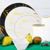 Flat lay showcasing marble charger with gold-rimmed plate and coordinated cutlery