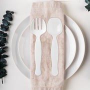 Guest serving a portion with a white plastic serving fork at a catered buffet, hygienic disposable serveware for self-serve stations and events.
