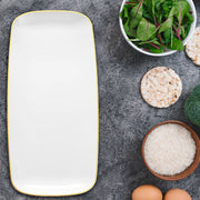Guests enjoyed finger foods on 10.6" x 5" gold-rimmed plates during a golden-toned party.