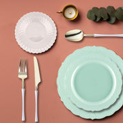 Guests enjoying desserts on turquoise vintage plates at a summer garden party.