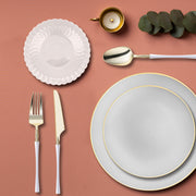 Guests enjoying formal meals on gray dinnerware with golden rims.