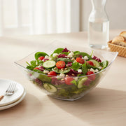 Guests served from 32 oz clear wave square disposable bowls at a catered gathering, sleek plastic serveware for effortless entertaining and cleanup.