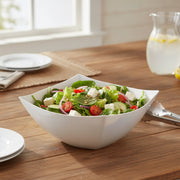 Guests served from 8 oz white wave square disposable bowls at a catered gathering, sleek plastic serveware for effortless entertaining and cleanup.
