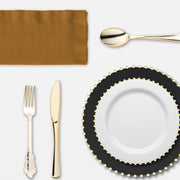 Holiday dinner spread featuring the Dear Santa Set‚Äôs gold cutlery and bold color palette