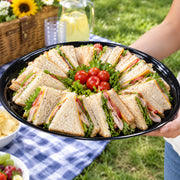 Hosts choose 16" Black Round Plastic Trays to keep appetizers organized while maintaining a sleek, coordinated look.