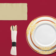 Intimate dinner setup featuring the Kiss at Midnight plates, napkins, and champagne glasses.
