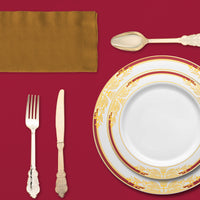 Intimate dinner setup featuring the Kiss at Midnight plates, napkins, and champagne glasses