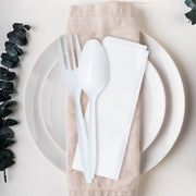 MW cutlery kits with fork, teaspoon, and napkin lined up at a cafeteria station, hygienic single-use utensil packs for fast-moving service lines.
