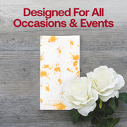 Modern and decorative white dinner napkins with gold splatter accents, ideal for elevating formal or festive meals