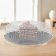 Modern black serving tray with crystal-clear cover pairs effortlessly with metallic cutlery and tumblers for cohesive party setups