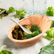 Outdoor party scene showcasing Oval Palm Leaf Eco Friendly Bowls filled with fresh foods and vibrant flavors