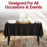 Outdoor wedding tablescape featuring gold-accented plates and black table linens for timeless elegance.