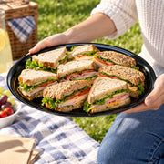 Oversized 18" Black Round Plastic Trays are ideal for self-serve snack stations, keeping food accessible while maintaining a polished look.