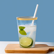 Party-ready setup with 12 oz. Clear with Metallic Gold Rim Round Tumblers positioned beside desserts and refreshments