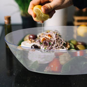 Premium clear oval plastic salad bowl featuring a colorful bean salad, chic disposable tableware for buffet stations and catering.