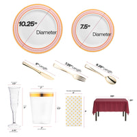 Red and gold chord rim plates placed on a burgundy table with gold-accented tumblers