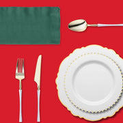 Red tablecloth and gold dinnerware from the Ho-Ho Haute Set create a sophisticated holiday table.