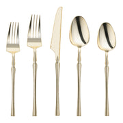 Shiny gold Moderno disposable plastic cutlery set with forks, knives, spoons, dessert forks, and dessert spoons
