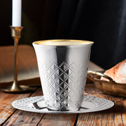 Shiny round plastic Kiddush Cups in silver shown on a festive table ready for religious celebration