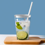 Sleek 12 oz. plastic tumblers with shimmering silver dots at a modern cocktail setup
