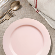 Soft pink matte plates styled at a brunch table with pastries, blush flowers, and light accents