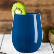 Solid Navy Elegant Stemless Plastic Wine Glass with smooth matte finish, garnished with a fresh kiwi slice