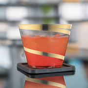 Stylish clear plastic cups with gold swirls, 9 oz capacity, round and disposable, great for celebrations