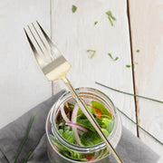 Stylish gold dessert forks, 7 inches, with a contemporary Moderno design; disposable for easy cleanup