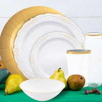 Table setup under soft lighting showcasing gold-accented plates and flatware.