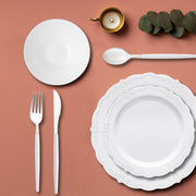 Vintage-style silver-rimmed plates styled for a classic wedding dinner.