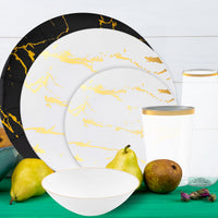 Wedding head table styled with black, gold, and white dinnerware.