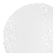 White plastic dinner plates featuring a silver antique floral pattern