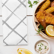 White and silver paper napkins displayed at a holiday dinner setup, adding sparkle to the celebration