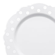 White disposable salad plate with a silver dotted blossom design