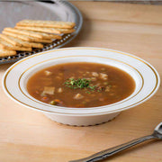 White plastic soup bowls featuring a gold edge rim, 12 oz., in a convenient 120-pack for formal or casual dining events
