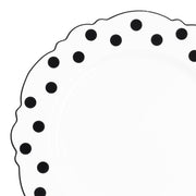 White round disposable plastic dinner plate with a black dot blossom design