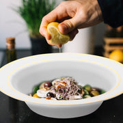White with Gold Edge Rim Plastic Soup Bowl (12 oz.) featuring a decorative gold rim, served with vegetables and olives