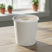Wide-base squat paper soup cups with lids arranged on a catering line ready for stews, mac and cheese, or warm desserts