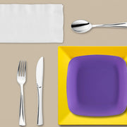 Yellow and purple Game Day Set arranged with cupcakes, chips, and spirited tablecloths